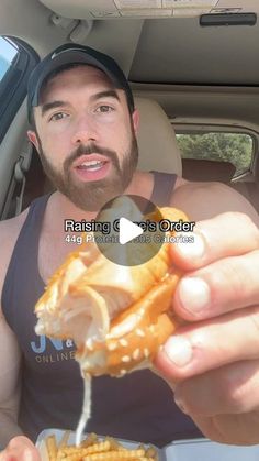 a man eating food in the back seat of a car