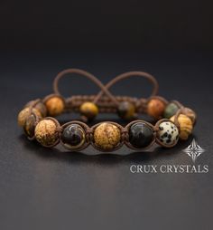 Handcrafted Men's Natural Stone Shamballa Bracelet made of 10mm mixed natural stone beads - Picture Jasper, Dalmatian Jasper, Yellow Tiger's Eye, Gold Obsidian, Brown Retro Agate, Russian Serpentine, and Coffee Mother of Pearl, all combined with dark brown shamballa waxed cord. The item ends with two Yellow Tiger's Eye beads as stoppers. Note: All men's bracelets can be made in a smaller women's size Just leave us a note with the order. Adjustable bracelet. For best results, please leave your wr Beaded Macrame Bracelet, Beaded Macrame, Eye Agate, Shamballa Bracelets, Beads Pictures, Stone Wrapping, Tiger Eye Beads, Macrame Bracelet, Gemstone Beaded Bracelets