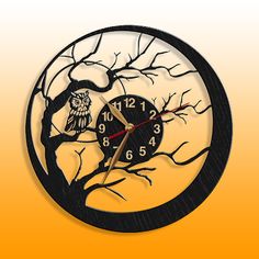 a clock with an owl sitting on a tree branch in front of a yellow background