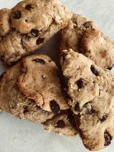 four chocolate chip cookies sitting on top of each other