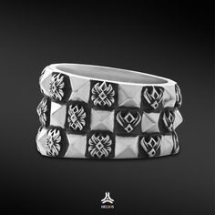 a ring with black and white designs on the inside, in front of a black background