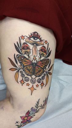 a woman with a butterfly tattoo on her thigh