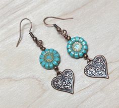 Super cute boho earrings perfect for spring and summer! For these I have paired Czech glass sunflower beads in turquoise blue with a copper wash, tiny copper beads, and antique copper scrolled heart charms. These adorable earrings are perfect for everyday, and make a lovely gift! Total length of earrings, including the ear wire, is approximately 2-1/8".   Thank you for shopping with The Lucie Collection! Bohemian Beaded Earrings With Heart Beads For Gift, Turquoise Bohemian Flower Earrings For Gift, Turquoise Heart Drop Earrings As Gift, Blue Bohemian Heart Earrings For Gift, Bohemian Blue Heart Earrings For Gifts, Bohemian Heart Beads Drop Earrings, Blue Bohemian Heart Earrings As Gift, Bohemian Turquoise Flower Earrings Nickel Free, Bohemian Beaded Heart Drop Earrings