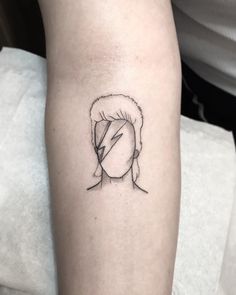 a person with a lightning bolt tattoo on their arm