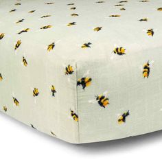 a white sheet with yellow and black bums on it, in front of a white background