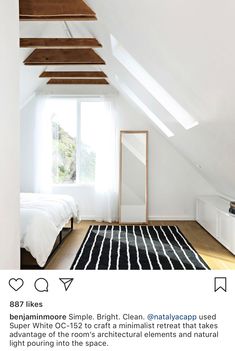 an attic bedroom with white walls and wood beams on the ceiling is featured in this instagram