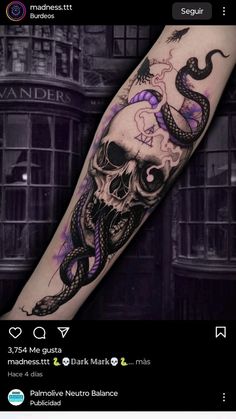 a skull and snake tattoo on the arm