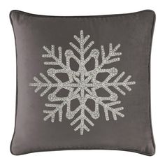 a grey pillow with white snowflakes on it