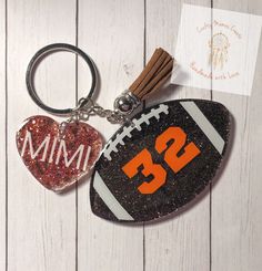 a football keychain with the number 29 on it and a heart shaped ornament