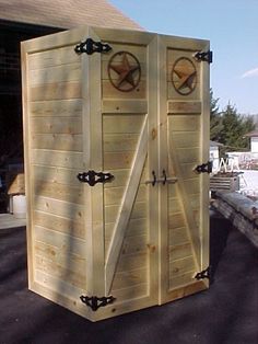 a large wooden storage shed with two doors