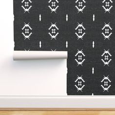 a black and white wallpaper with an abstract design on it, next to a wooden floor