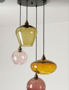 three different colored lights hanging from a ceiling