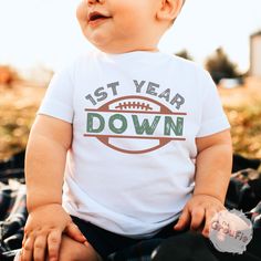 a baby wearing a tshirt that says 1st year down