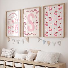 three framed pictures hang on the wall above a wooden bench with pillows and pillow cases