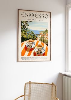 there is a poster hanging on the wall above a table with two cups and saucers