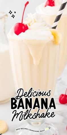 two glasses filled with banana milkshake and topped with whipped cream, cherries, and a cherry