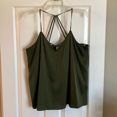 Silky Material Army Green Cami/Tank Top. Racer Back Style Back That Has 4 Connection Points To The Top. 97% Polyester. Armpit To Armpit Measures 19” Laying Flat. Only Warn A Couple Times. Like Brand New. No Flaws Or Stains. Smoke Free Home. Green Vest Tops With Tank Straps, Green V-neck Tank Top For Night Out, Green Tank Top For Night Out, Green Cami Tank Top For Night Out, Green Cami Top For Day Out, Green Cami Top For Night Out, Green Cami, Green Top, Green Tops