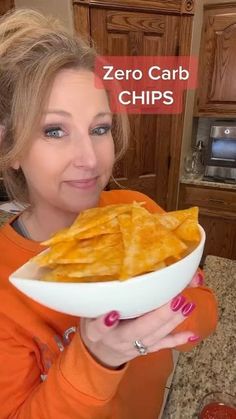 a woman holding a plate with some food in it and the caption zero carb chips