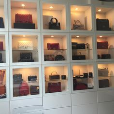 the shelves are filled with many different types of purses