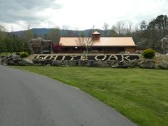 there is a sign that says little ones on it in front of a building with mountains in the background