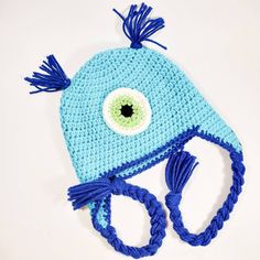 a blue crocheted hat with an eye on it