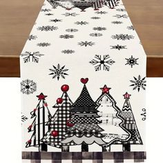 a christmas table runner with trees and snowflakes on it