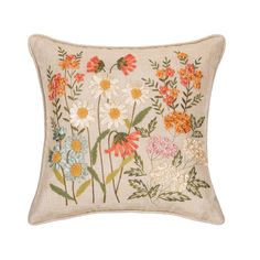 an embroidered pillow with flowers on it