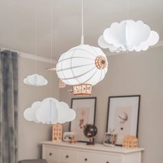 there are clouds hanging from the ceiling in this room with a hot air balloon on it