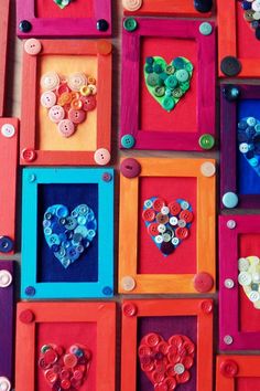 several colorful frames with buttons in them on the wall, and one has a heart shaped button