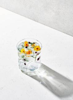 a glass filled with water sitting on top of a white counter