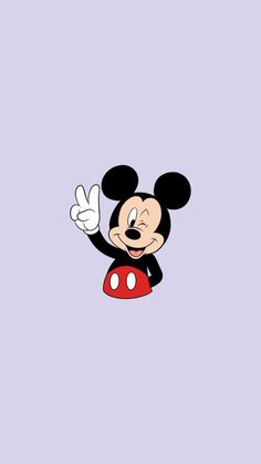 mickey mouse flying through the air with his hands in the air and pointing at something