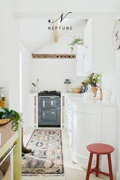 a kitchen with an oven and rug on the floor