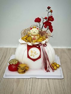 a white pumpkin with gold coins and a teddy bear in it