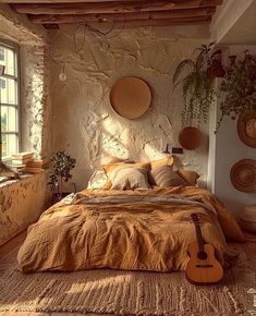 a bed room with a neatly made bed and a guitar hanging on the wall next to it