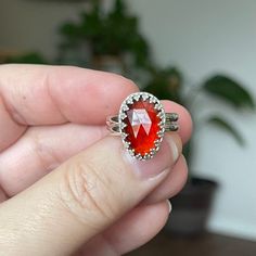 A really flashy faceted Garnet with a sterling silver crown bezel.  She sits on a double wire sterling silver band and has a shiny finish.  Very pretty and sparkly with movement!! Measurements:  17mm x 13mm Ring Size:  7 Garnet is a bright red, fiery crystal of passion. It is considered one of the oldest crystals used for spiritual protection throughout history. The spiritual meaning of Garnet is that it is the embodiment of the energies of fire, passion, creativity, and strength. When you purch Sterling Silver Faceted Rings For Jewelry Making, Faceted Crystal Ring In Sterling Silver, January Birthstone Rings, Sterling Silver Garnet Ring, Handmade Silver Jewelry, Spiritual Protection, Silver Crown, January Birthstone, Spiritual Meaning