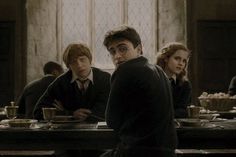 harry potter and his friends are sitting at the table