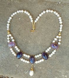 This necklace is 18in long, and is made with gold wash accents, freshwater pearls and purple amethyst. The stones are bright purple with neat occlusions. No two are perfectly alike!  This necklace is sure to be a sumptuous addition to any attire. Giftwrap is available, as are pearl earrings to match! Purple Amethyst Pearl Necklace, Purple Amethyst Pearl Necklace With Gemstone Beads, Purple Amethyst Gemstone Beads Pearl Necklace, Purple Pearl Jewelry With Natural Stones, Purple Pearl Drop Jewelry, Purple Amethyst Jewelry With Pearl Pendant, Purple Pearl Drop Round Bead Jewelry, Purple Pearl Jewelry With Gemstone Beads, Purple Pearl Necklace With Pearl Pendant