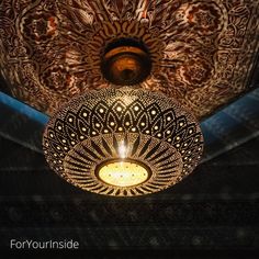 an intricately designed light fixture hangs from the ceiling