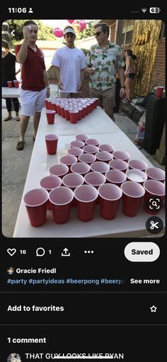 two men standing next to each other at a table with red cups on top of it