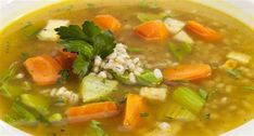 a white bowl filled with soup and vegetables