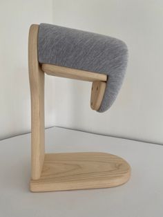 a wooden chair with a gray cushion on it