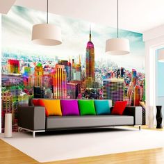 a living room with a colorful couch and large cityscape on the wall behind it