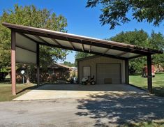 a large carport in the middle of a park with two cars parked under it