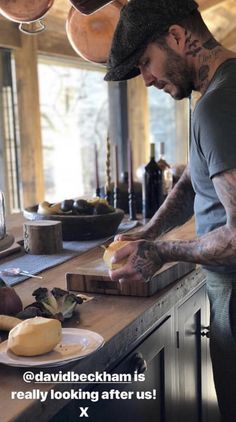 a man cutting up food on top of a wooden counter