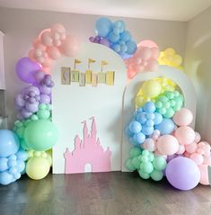 there are balloons in front of the castle on the wall and at the entrance to the room