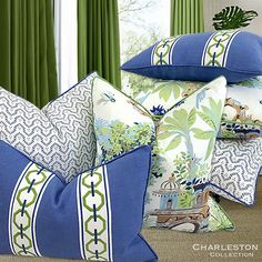 blue and white pillows with green curtains in the background