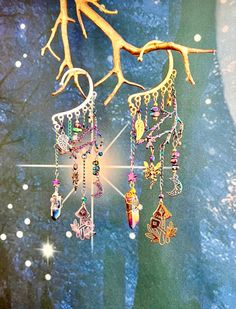 This enchanting fairy forest ear cuff is sure to make a statement and bring out your inner magic! Gold or silver ear cuff wrap is adorned with an electroplated rainbow tree branch, iridescent glass beads, fairy, moon, star, leaf, and mushroom charms, and a hand wire wrapped rainbow quartz crystal. This ear cuff is perfect for adorning non-pierced ears and pierced ears! Please note that each quartz crystal is unique so the shape, size, and coloration may vary slightly from what is shown in the Fantasy Festival Dangle Earrings, Fantasy Dangle Earrings For Festival, Fantasy Style Festival Ear Cuff, Fantasy Style Festival Ear Cuff For Pierced Ears, Handmade Dangle Ear Cuff For Festivals, Fantasy Festival Earrings, Bohemian Style Festival Ear Cuff, Fantasy Style Single Earring For Festival, Bohemian Ear Cuff For Pierced Ears