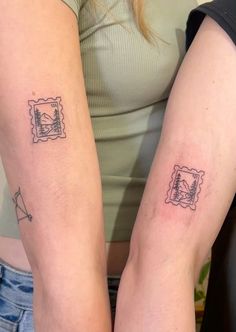 two people with matching tattoos on their arms, one has a stamp and the other has an image