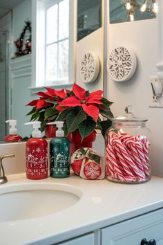 a bathroom sink with christmas decorations and candles on it's counter next to a mirror