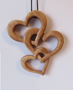 three wooden hearts hanging on a string